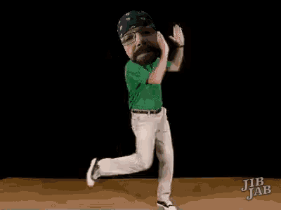 a man with a beard and glasses is dancing on a dance floor .