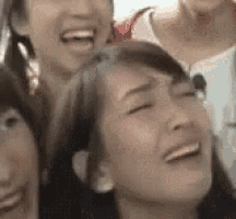 a group of women are laughing and making funny faces together .