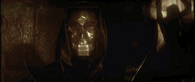 a person in a dark room with a green light coming out of their mouth