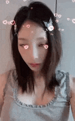 a close up of a woman 's face with hearts on it and a cat headband .
