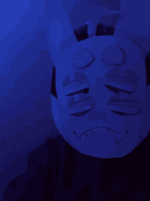 a person wearing a white mask with the word boo written on it