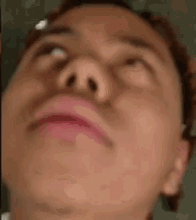 a close up of a person 's face with their eyes closed .