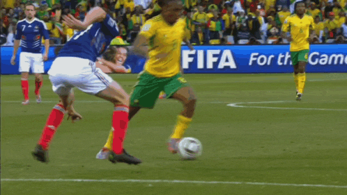 a soccer ball is flying through a net on a field