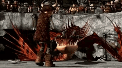 a man is standing next to a dragon in a ring .