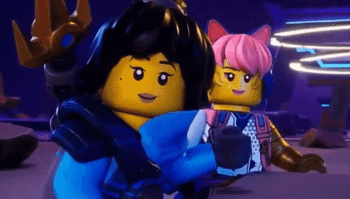 a couple of lego characters are standing next to each other .