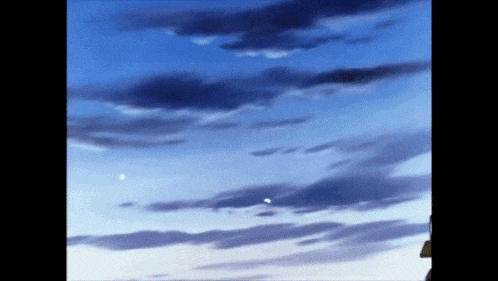 a blue sky with a few clouds and a few stars