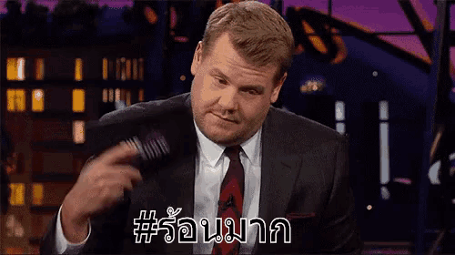 a man in a suit and tie is cutting a piece of meat with a knife .