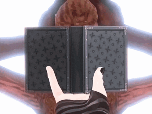 a person holding a book with a pattern of crosses