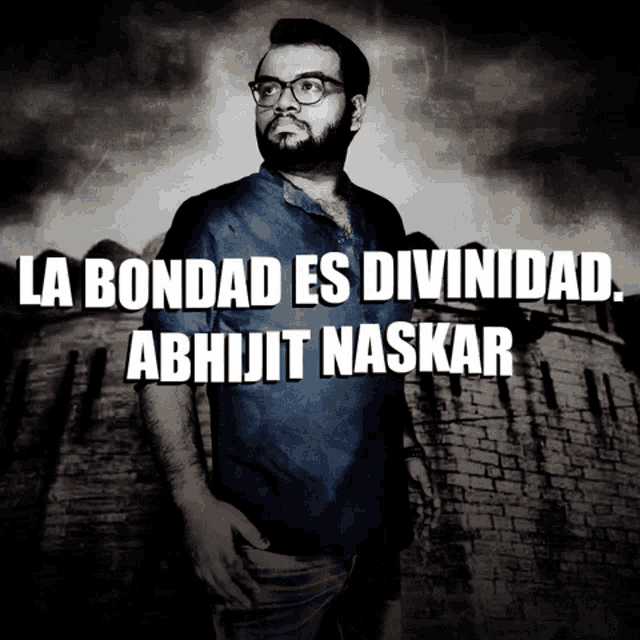 a man stands in front of a brick wall with the words la bondad es divinidad abhijit naskar
