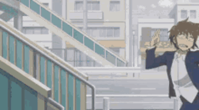 a man in a suit and tie is standing in front of a staircase .