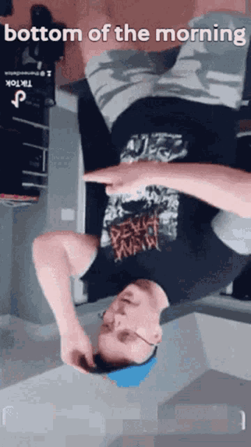 a man is laying upside down in front of a mirror with the words bottom of the morning written above him