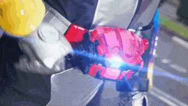 a person in a suit is holding a red and pink object