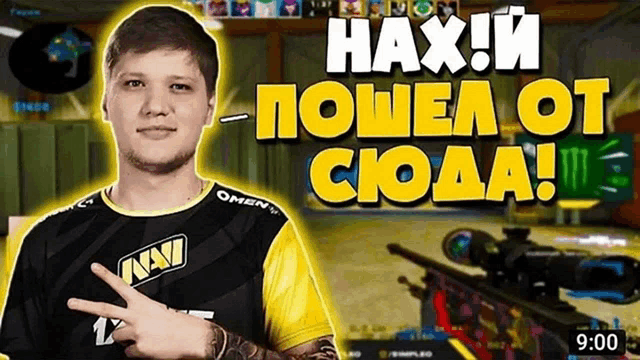 a man in a navi shirt stands in front of a video screen