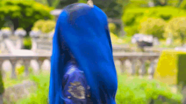 a woman with blue hair and a blue dress is standing in a garden .