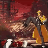 a man in a yellow robe is kicking another man in the face .