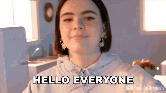 a woman says hello everyone in front of a youtube originals logo