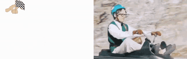 a man wearing a helmet and glasses is riding a sled down a hill .