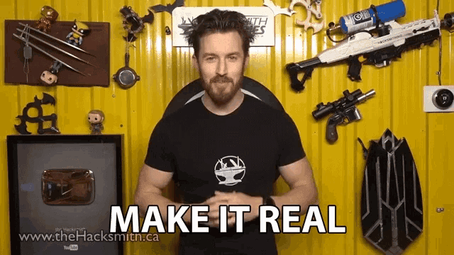 a man stands in front of a yellow wall and says " make it real "