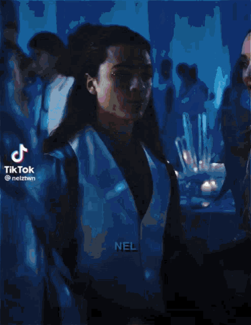 a woman in a black dress is dancing with a man in a white shirt
