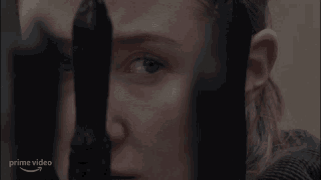 a close up of a woman 's face with the words prime video on the bottom left