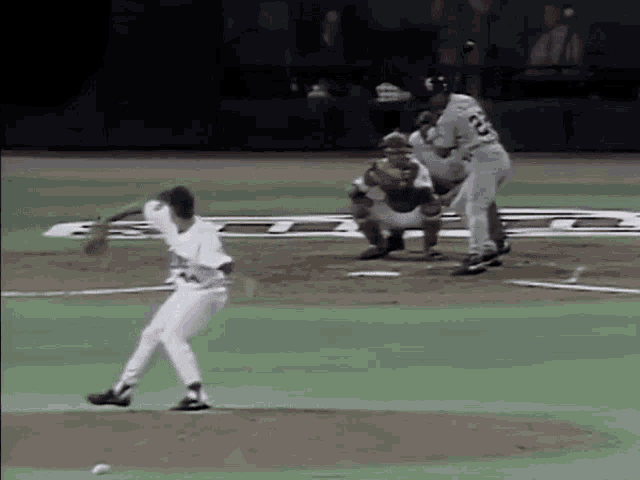 a baseball player with the number 23 on his jersey is throwing a ball