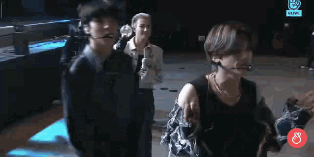 a group of young men are standing next to each other in a dark room .