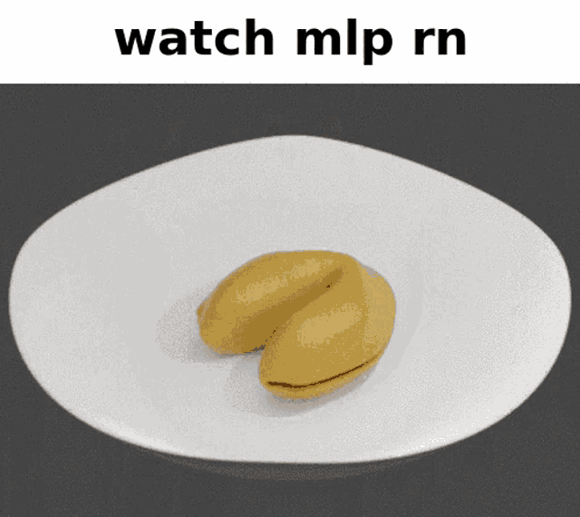 a yellow fortune cookie on a white plate with the words watch mlp rn below it