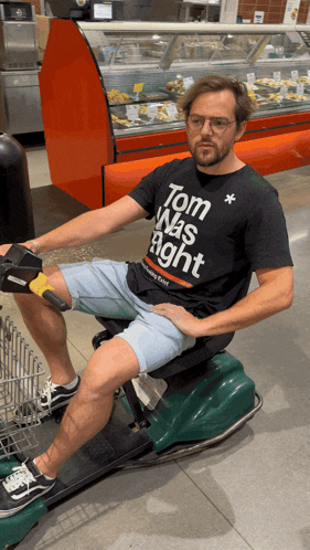 a man wearing a black shirt that says tom was right on it