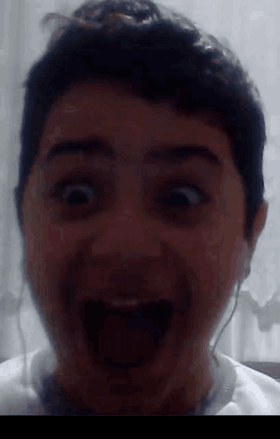 a close up of a person 's face with a surprised look on his face