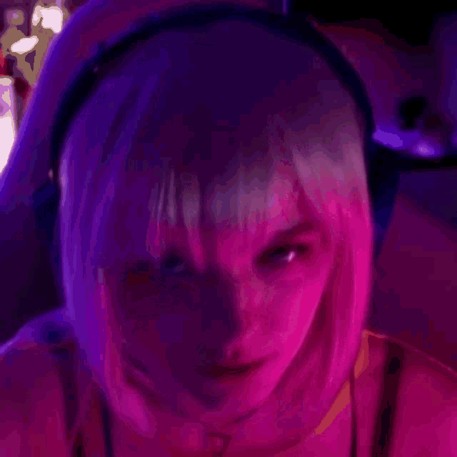 a close up of a woman wearing headphones in a dark room .