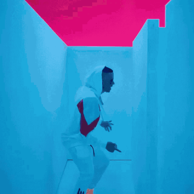 a man in a white hoodie is standing in a maze