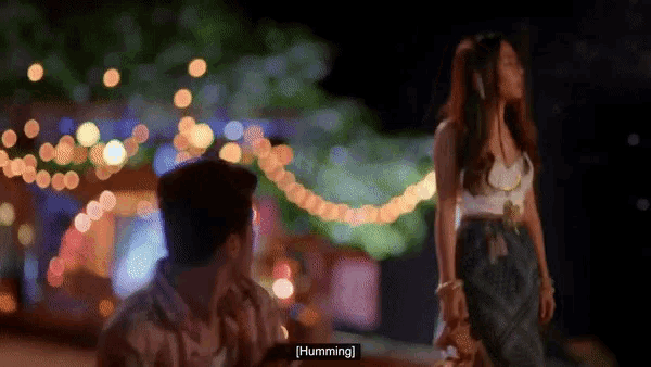a blurry picture of a man and a woman with the word humming visible