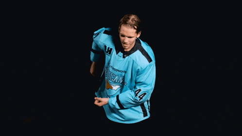 a hockey player wearing a blue jersey with the number 44 on his sleeve