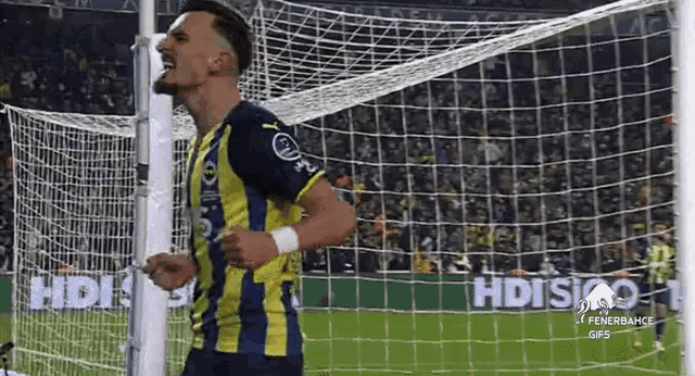 a soccer player is celebrating after scoring a goal during a game .