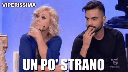 a man and a woman are sitting next to each other and the man is covering his mouth with his hand while the woman looks at him