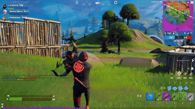 a screenshot of a video game called fortnite shows a man standing in the grass