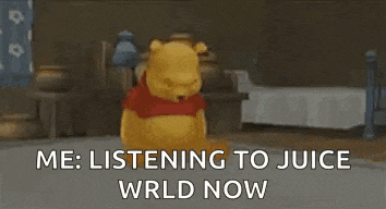 winnie the pooh is sitting on the floor in a room .