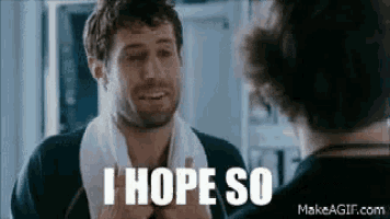 a man with a towel around his neck is crying in front of a mirror .