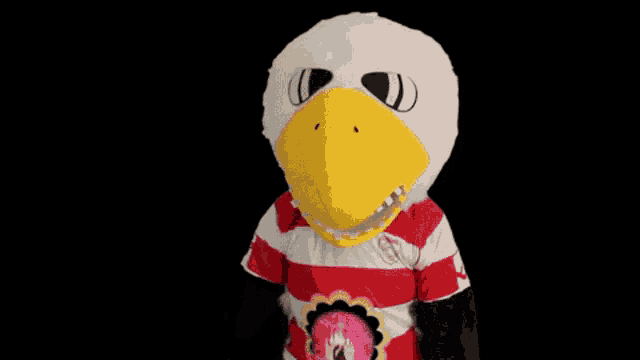 a mascot wearing a red and white striped shirt with an eagle on it