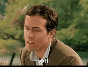 a man in a suit and tie is sitting on a bench with his eyes closed and his mouth open .