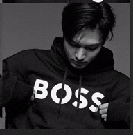 a black and white photo of a man wearing a black boss hoodie