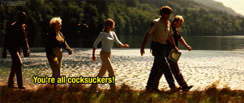a group of people walking by a body of water with the words you 're all cocksuckers