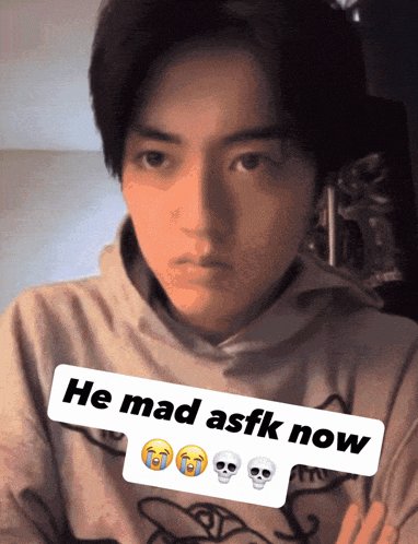 a man wearing a hoodie with the words he mad asfk now