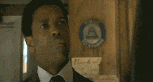 a man in a suit and tie says " my goon "