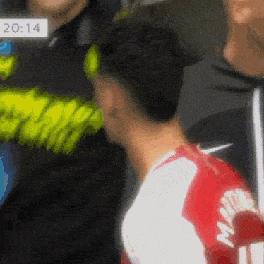 a soccer player wearing a red and white jersey with the name martin on the back