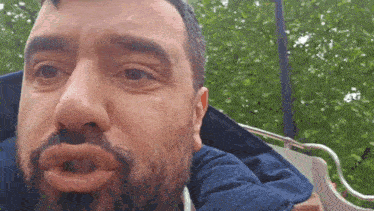 a man with a beard is making a funny face with his mouth open