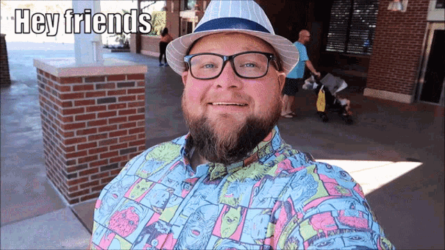 a man wearing a hat and glasses is smiling with the words hey friends above him