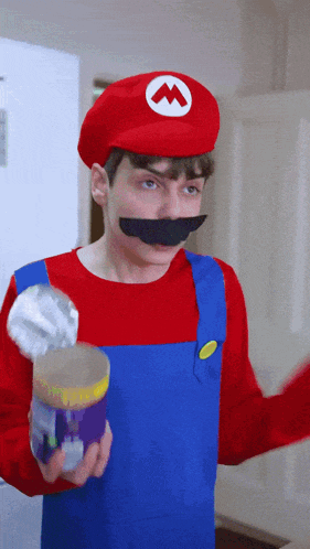 a man in a mario costume is holding a can of food