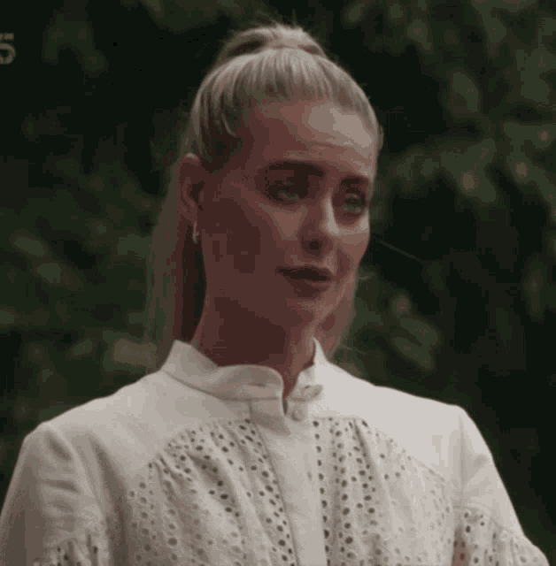 a woman in a white shirt has the number 5 on her shirt