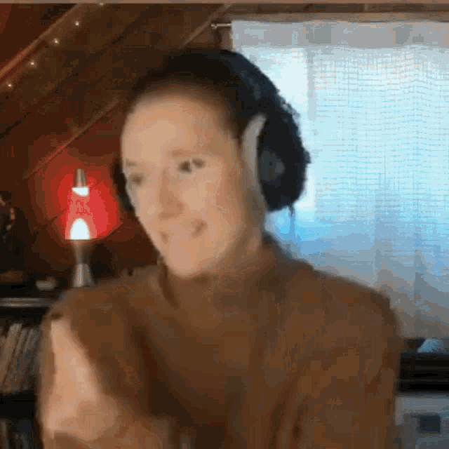 a woman wearing headphones is dancing in a room